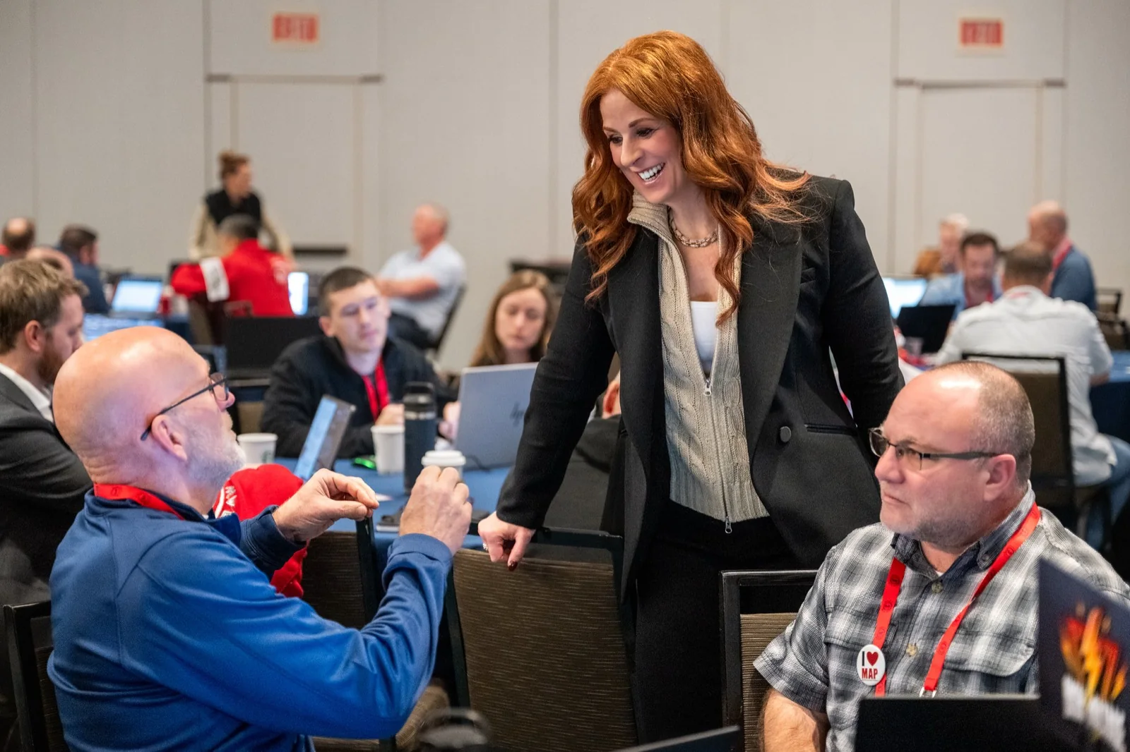 Robin Robins working one-on-one with MSP owners at a workshop table