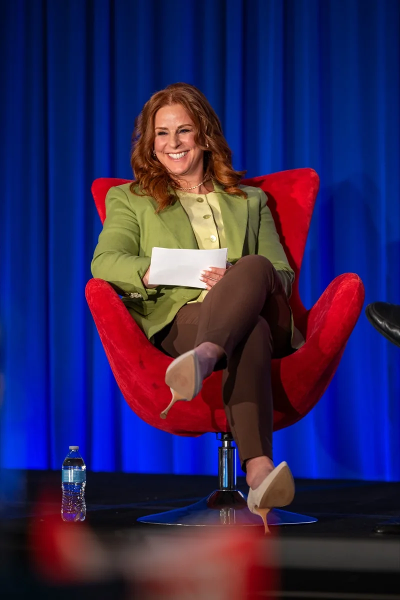 Robin Robins presenting on stage at an MSP event